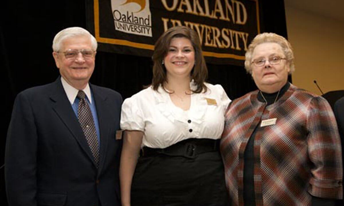 Three people smiling at the camera.