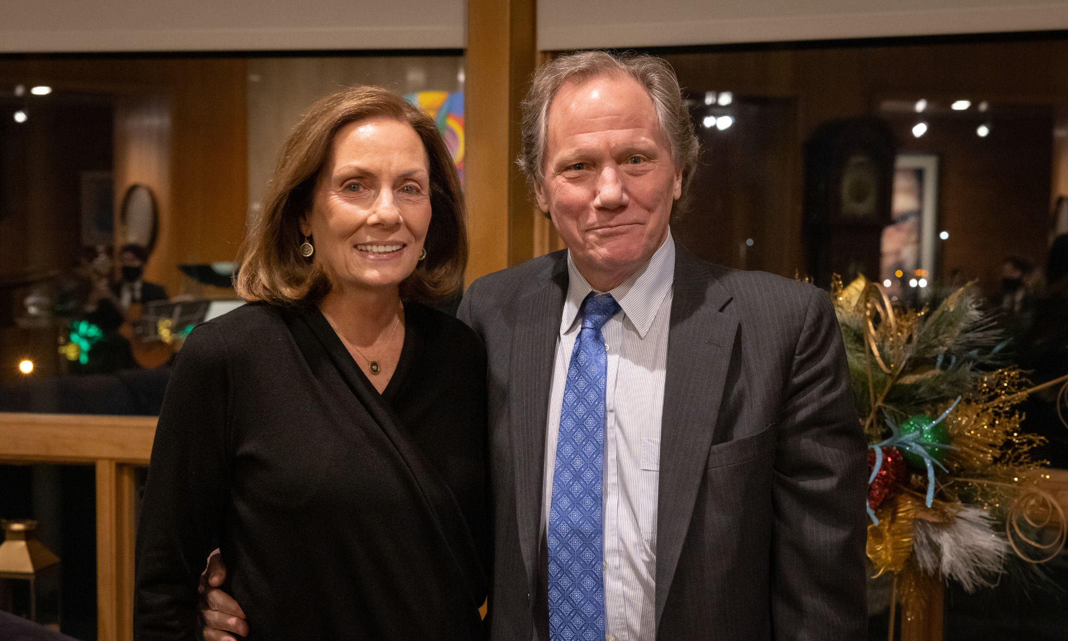 Male and female couple standing inside