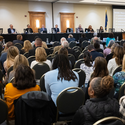 A group of people at a Board of Trustees meeting