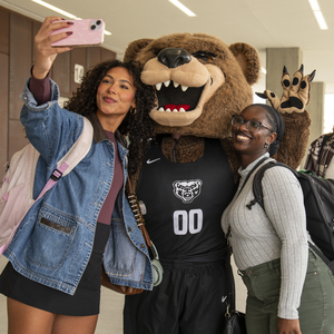 Students posing with the Grizz mascot