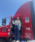 Jenna Baer standing in the door of a semi truck