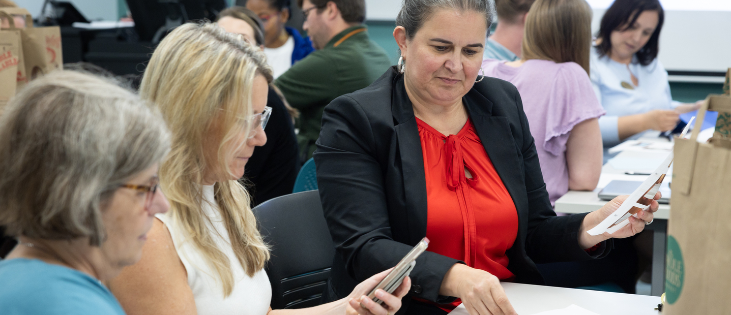 Professionals reviewing notes at lecture