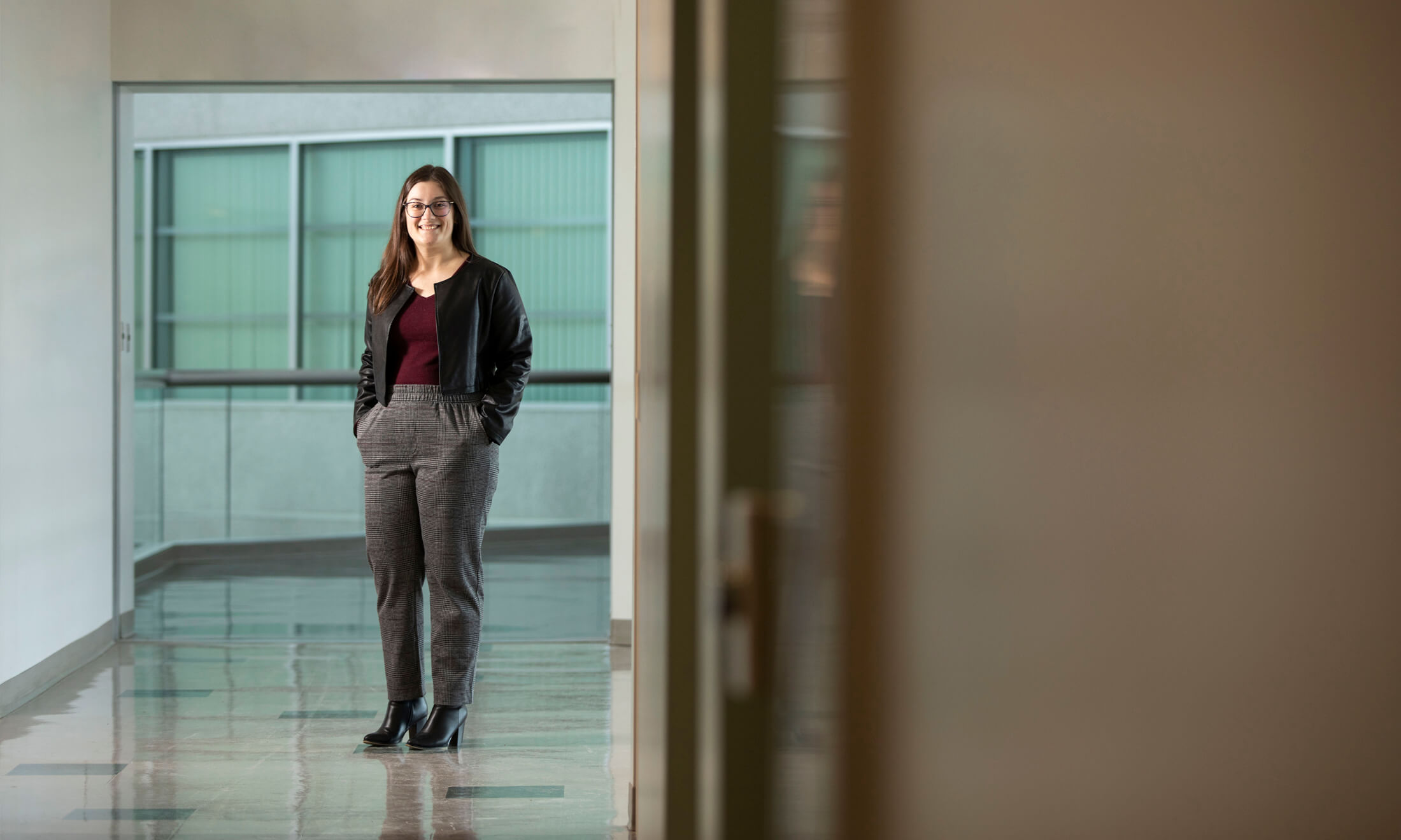 Photo of Elaina Bicego standing in a hallway