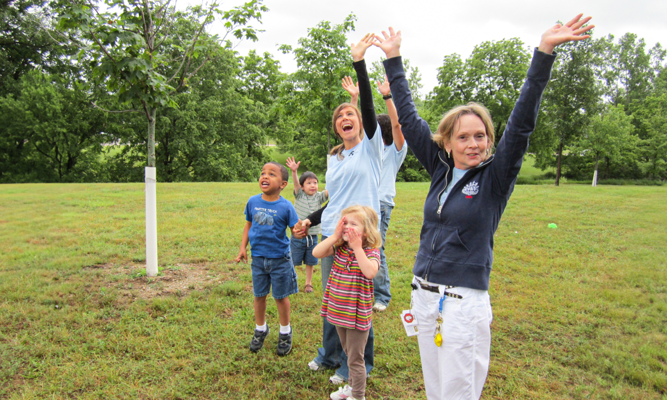 Bette Salisbury Slowinski cheering on a group of OUCARES Pee Wee campers during outdoor games