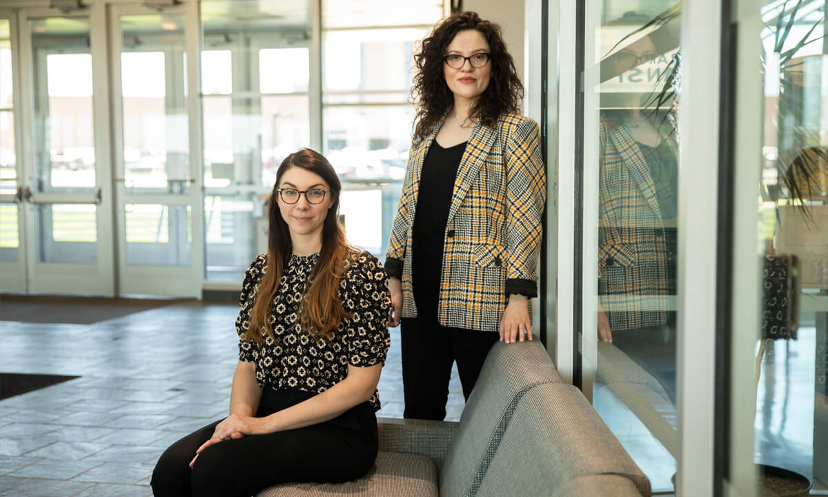 Photo of two female student smiling at the camera