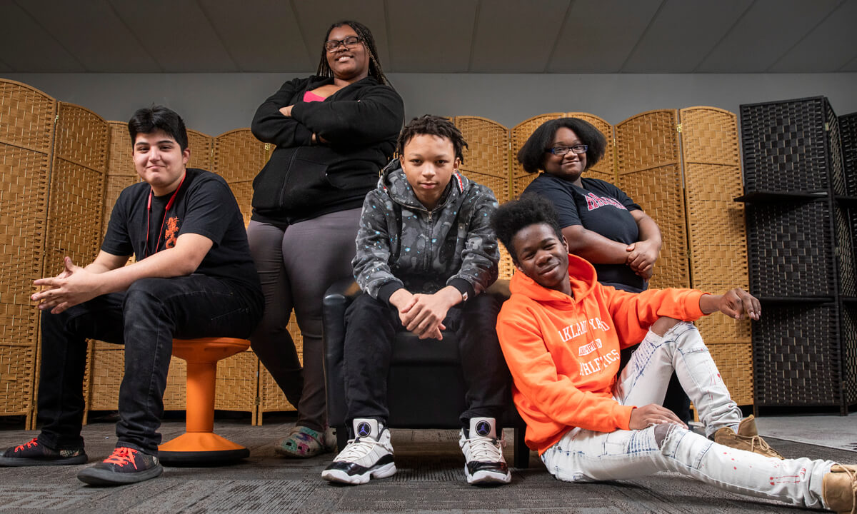 Group of high school students seated in a classroom looking at the camera