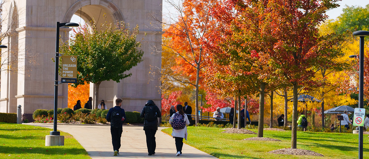 Students walking on Oakland University's campus in fall