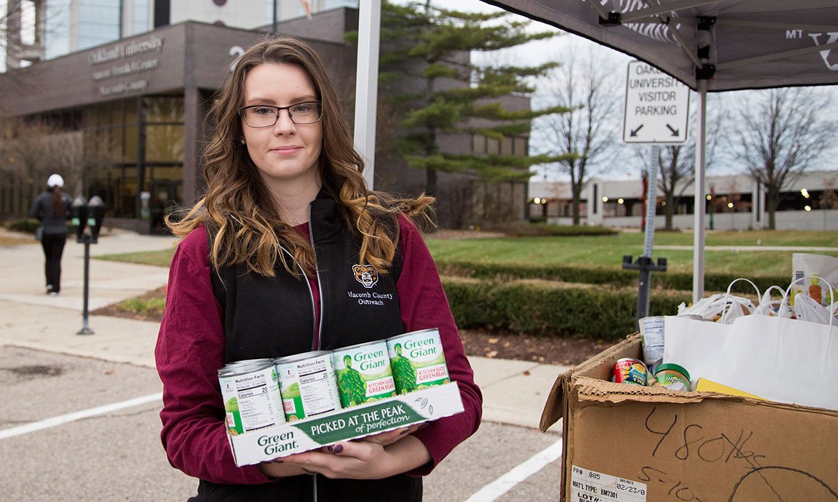 A woman holding canned goods.