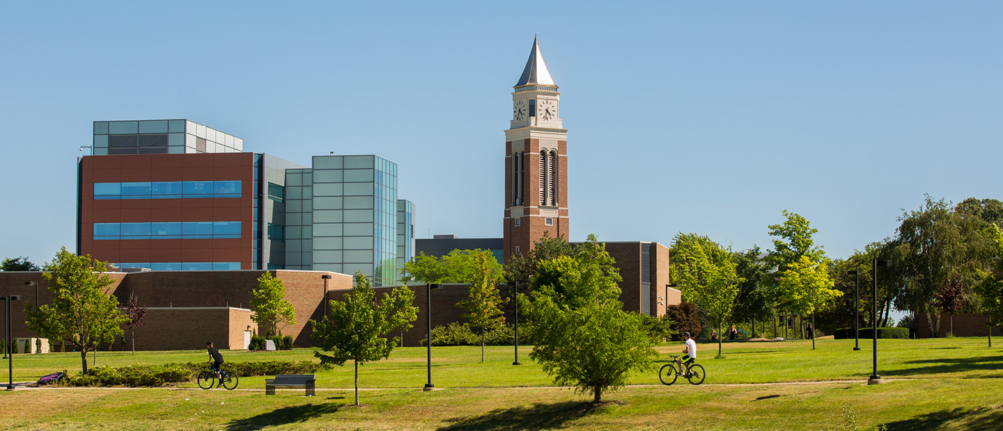 Elliott Tower and a blue glass and brown brick building on Oakland University's campus.