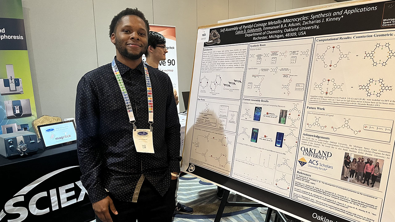 Calvin Goldsmith stands next to his research post.