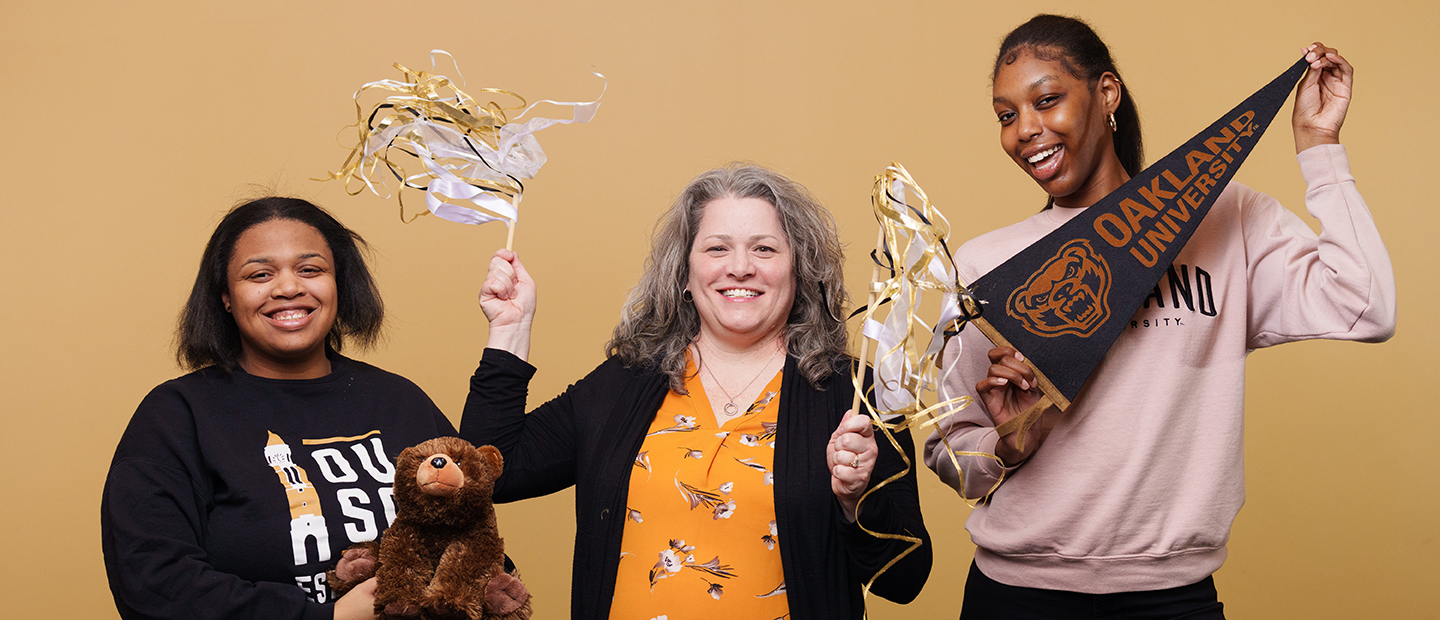 Oakland University staff with banners and pom poms