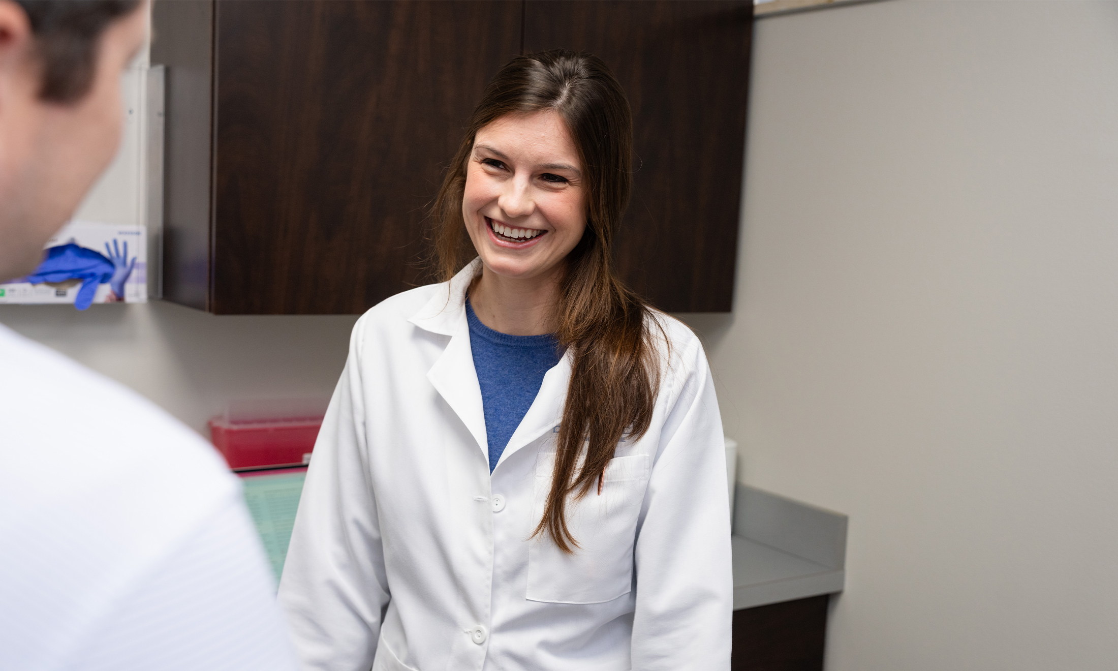 Elizabeth Paluga, M.D., talks with a patient