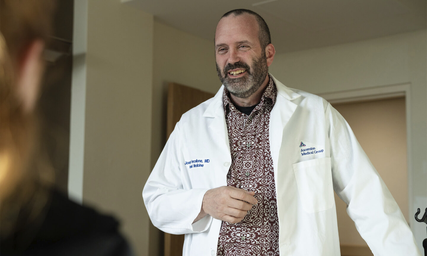 Joe Vercellone, M.D., talks with a patient
