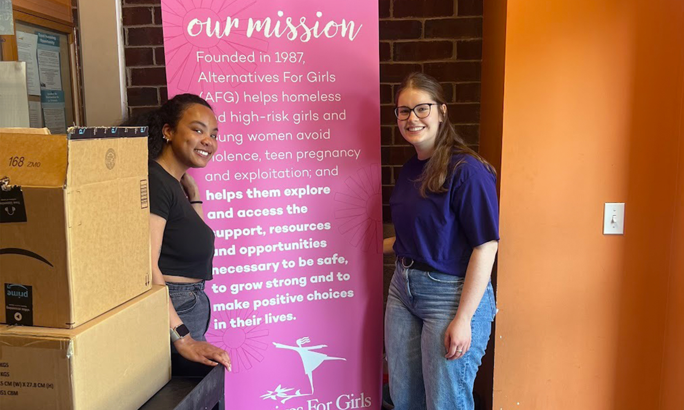 Mia Johnson and Claire Kopachik drop off care packages HRA put together for recent high school graduates for Alternatives for Girls.