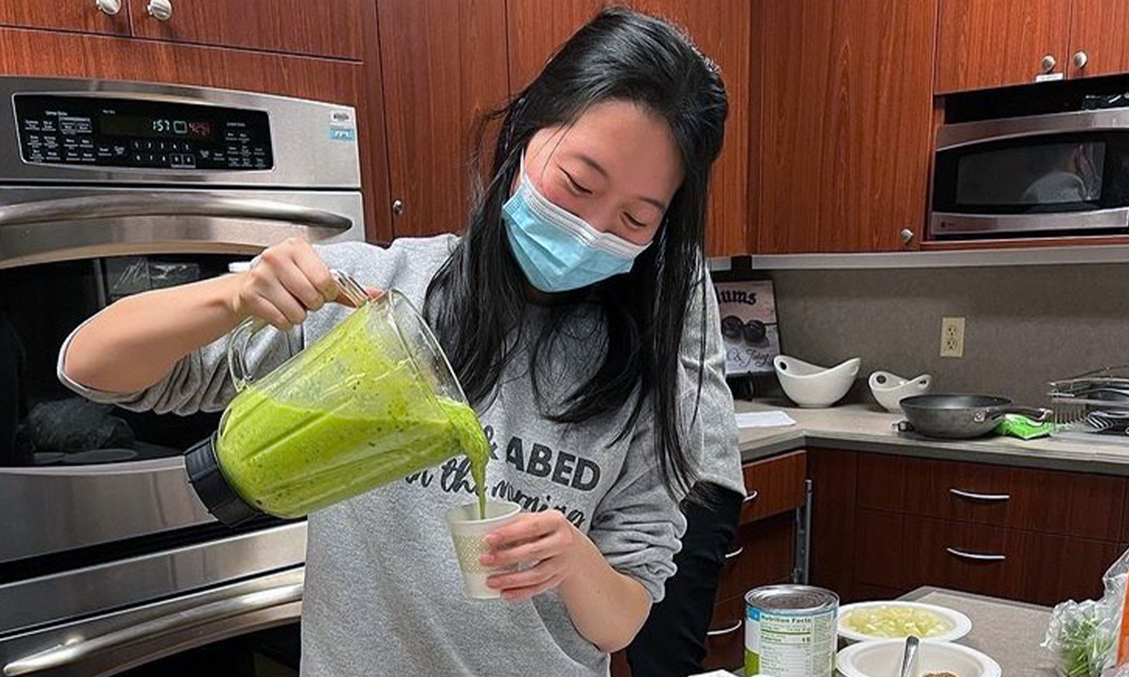 An image of a student pouring a smoothie