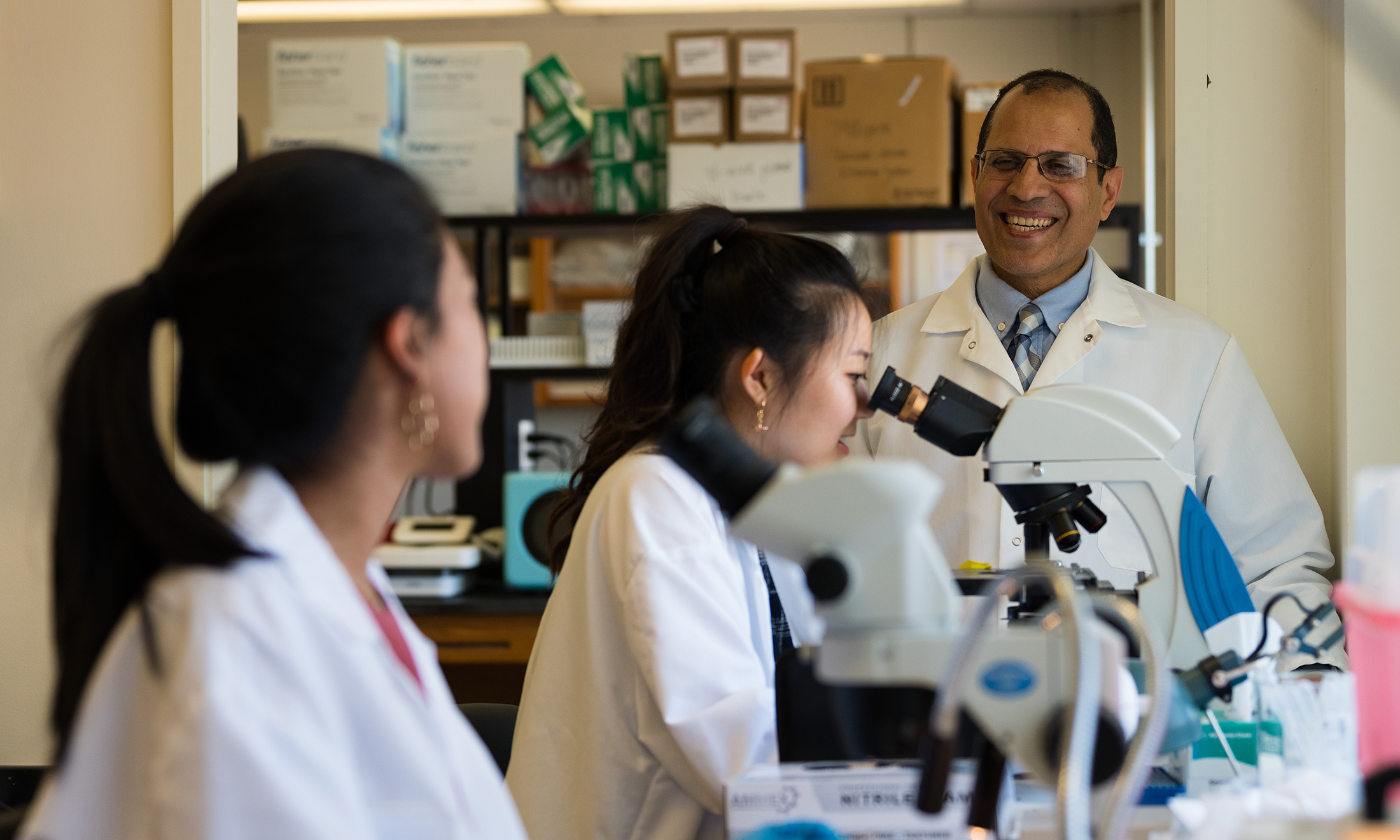 Student looking into microscope