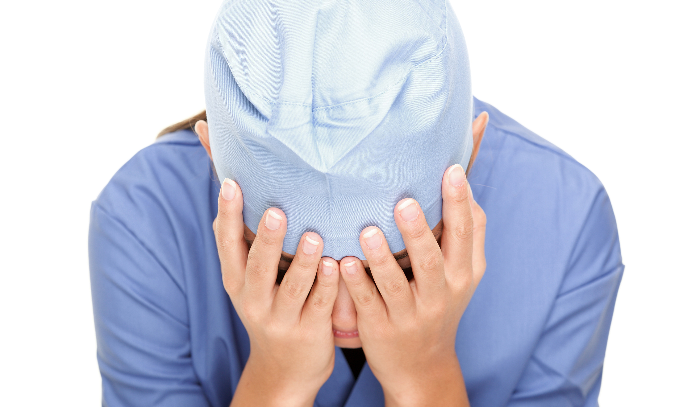 An image of a person in scrubs who appears to be upset.