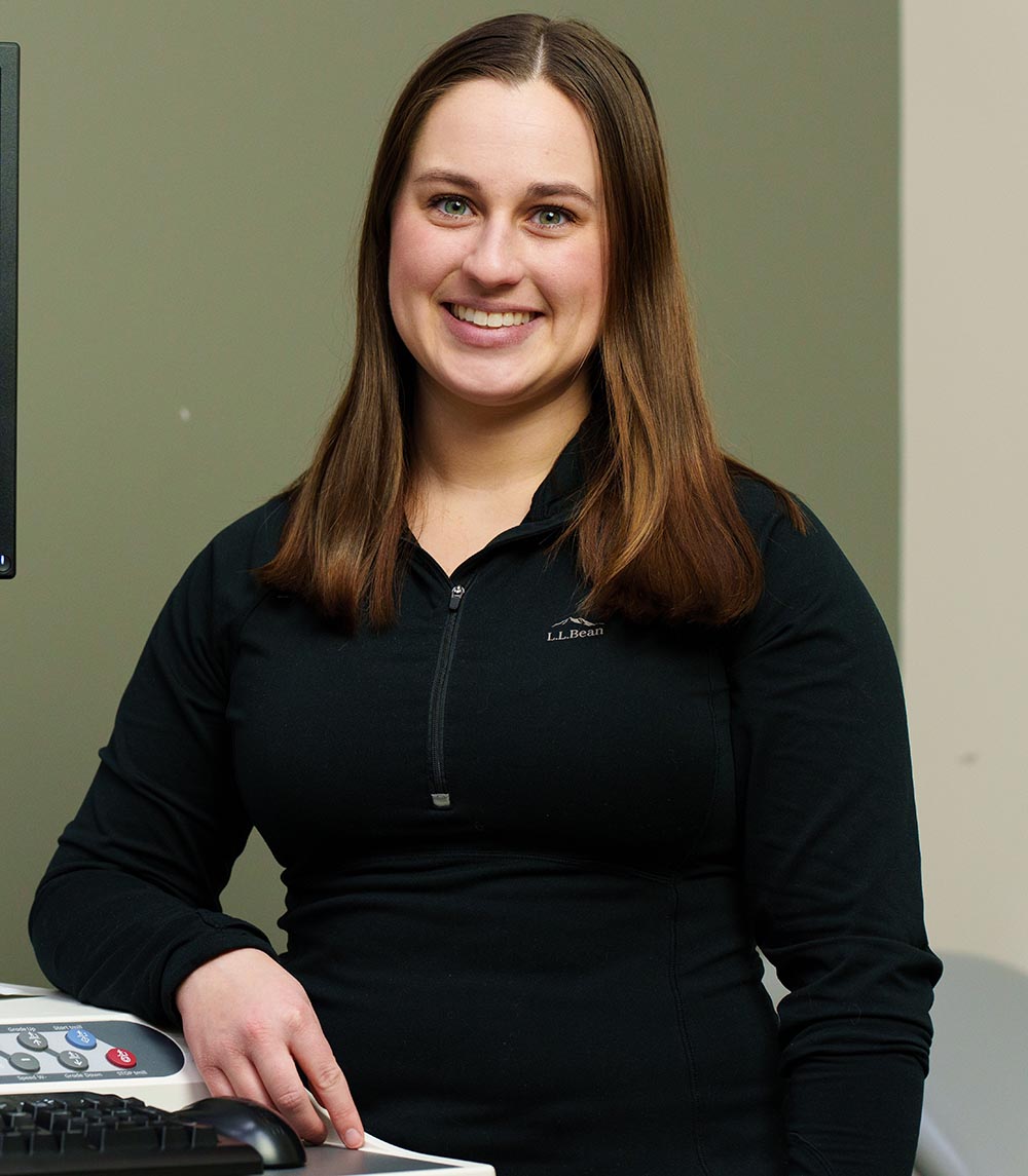 Woman standing and smiling at the camera