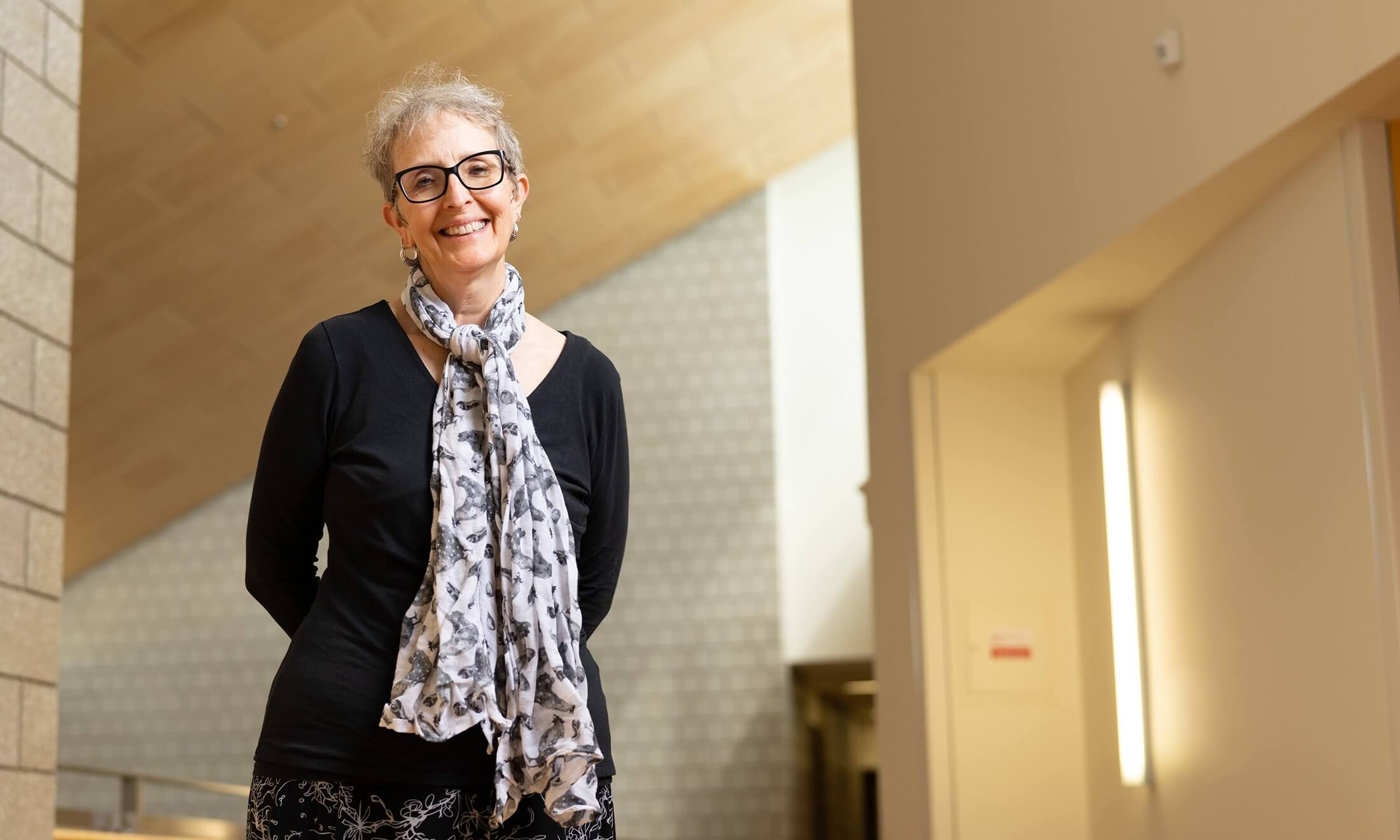 A woman standing in a hallway