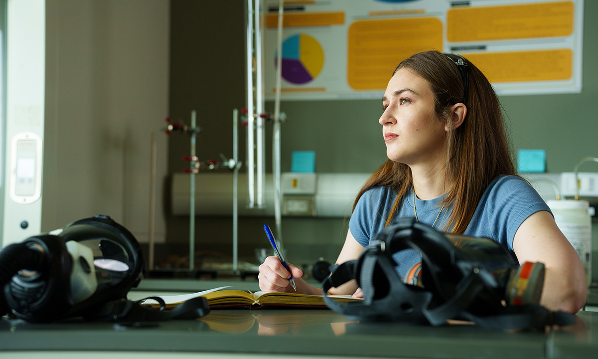 Deanna Fochesato looks up from writing and gazes into the distance