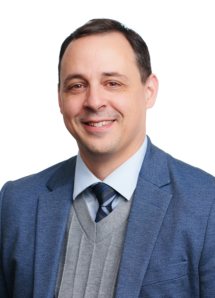 A headshot of Adam Crumpton