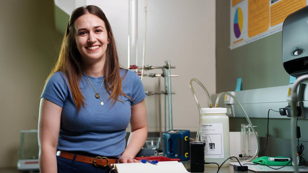 Female student in blue shirt standing in lab