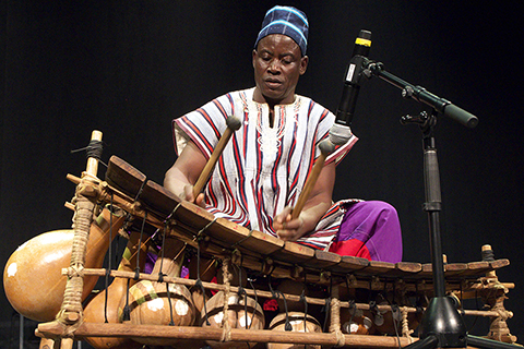 A man playing an instrument on stage.