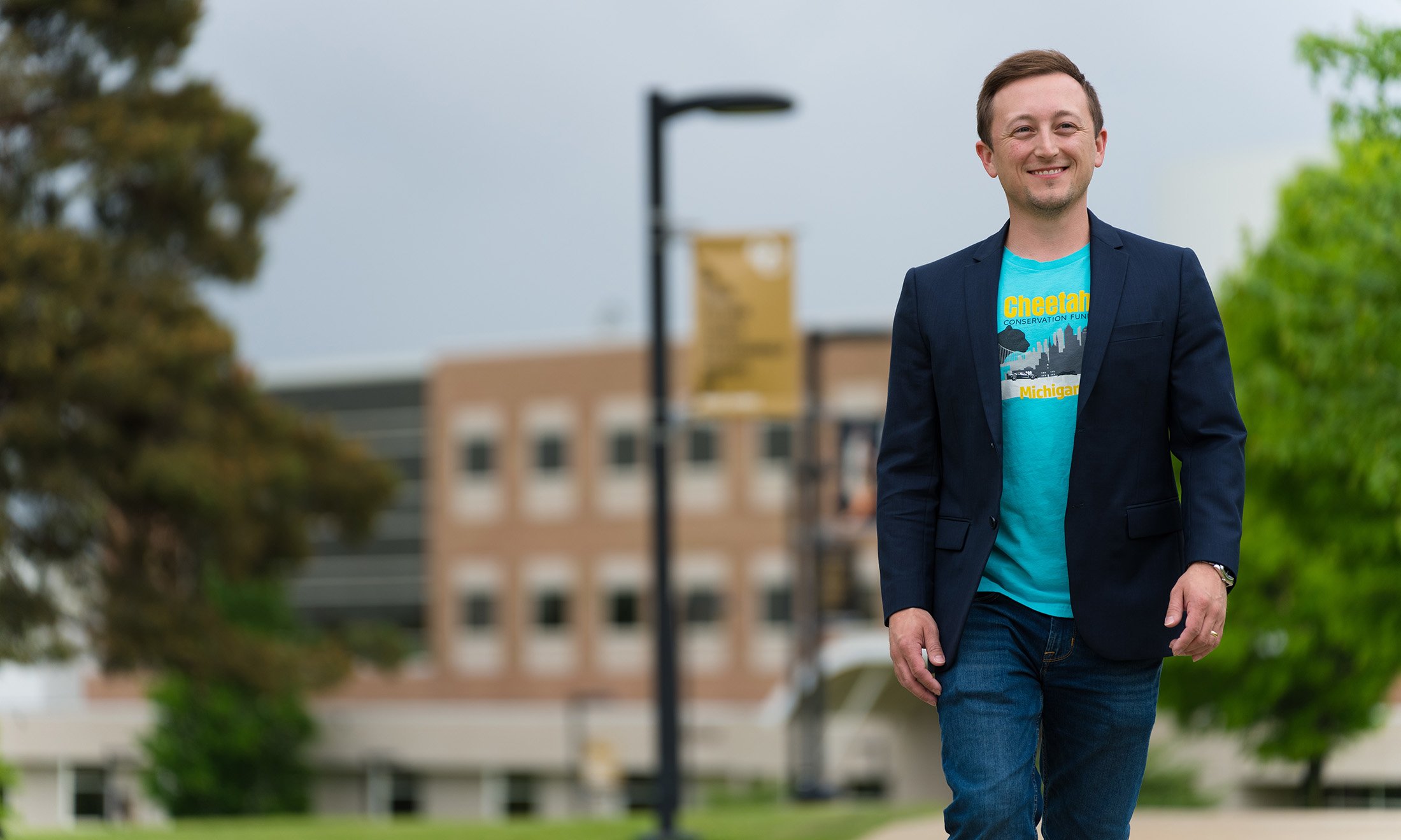 Image of Travis Peterson walking through Oakland University's campus