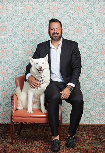 A man with his dog posing for a photo