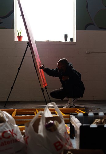 A man working on a painting