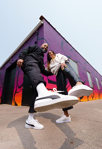 Two people showing off their shoes