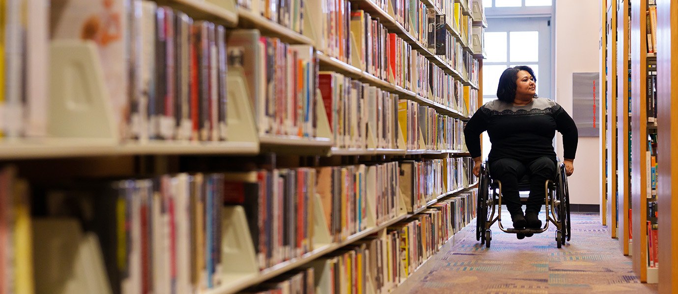 A person in a wheelchair in a library