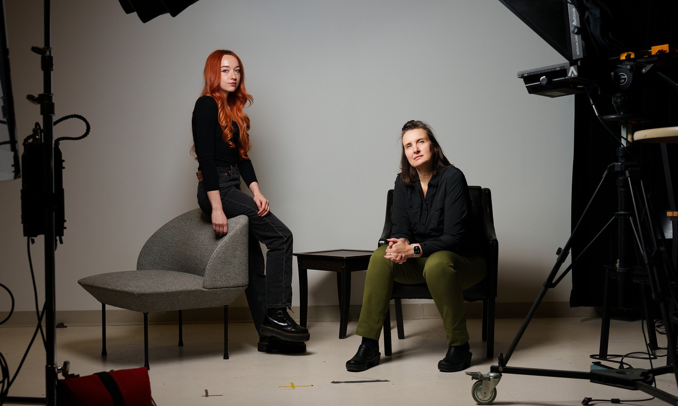 Two people sitting in a photo studio