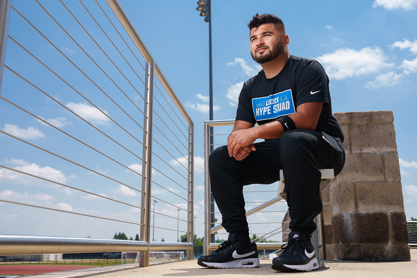 A man sitting next to some handrails