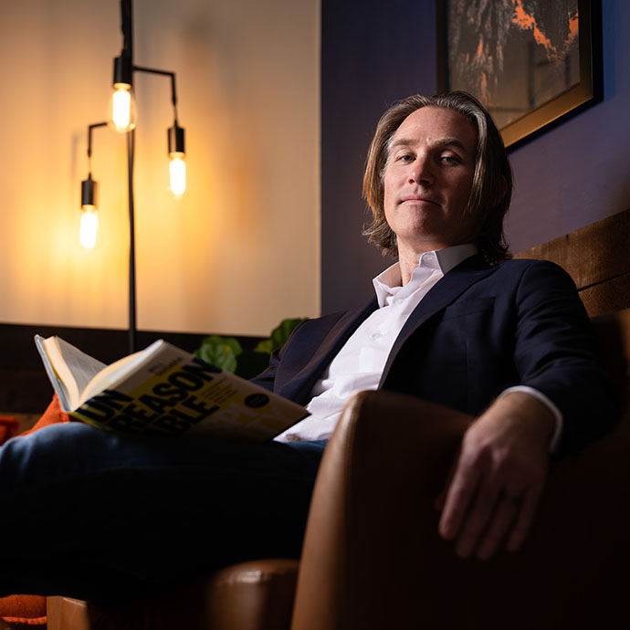 Man sitting in chair with book