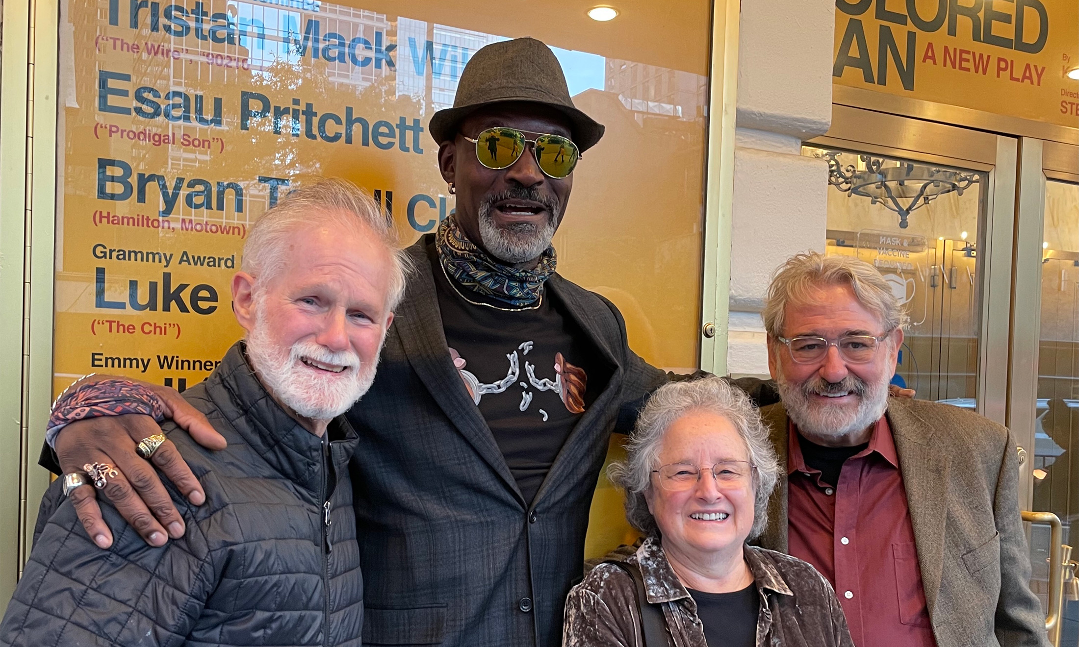 A group of four people smiling for a photo