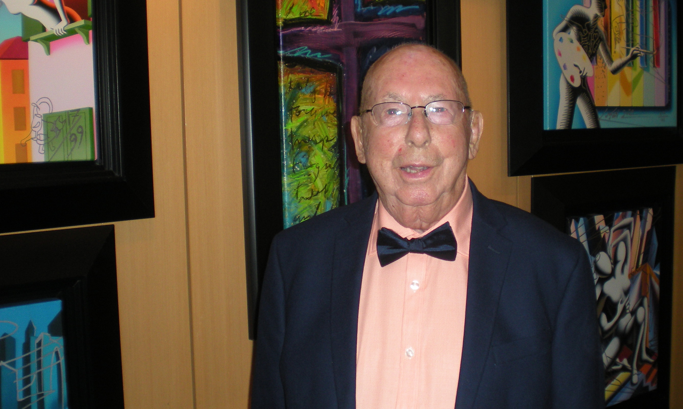 A man standing in front of art work