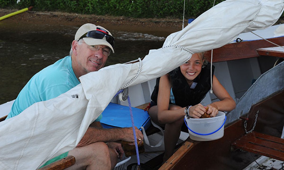 An older man and child on a boat