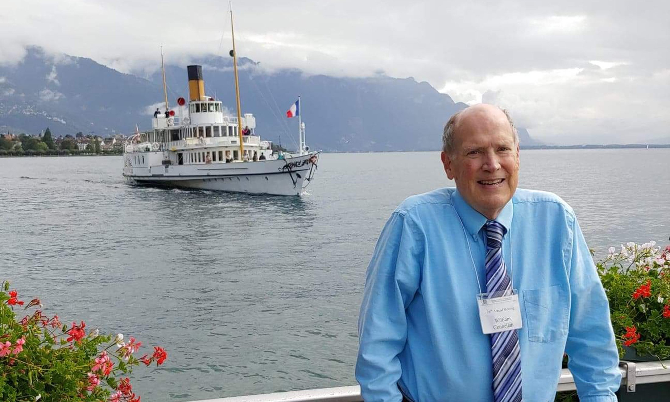 A man standing outside with a ferry behind him
