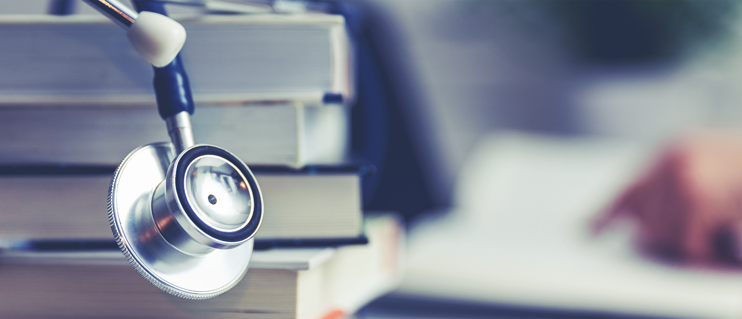 An image of a stethoscope and books