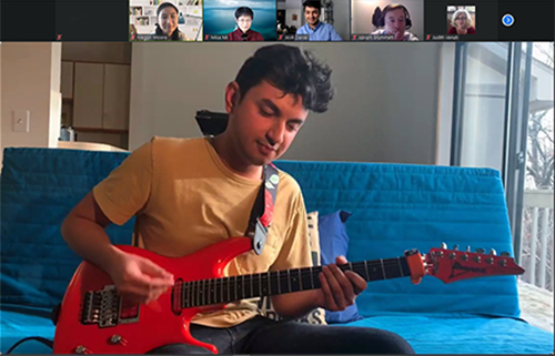 An image of a man playing guitar