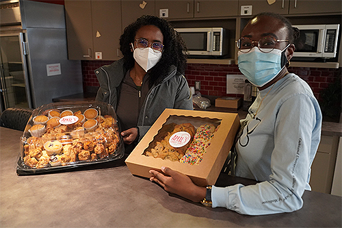 An image of students holding food