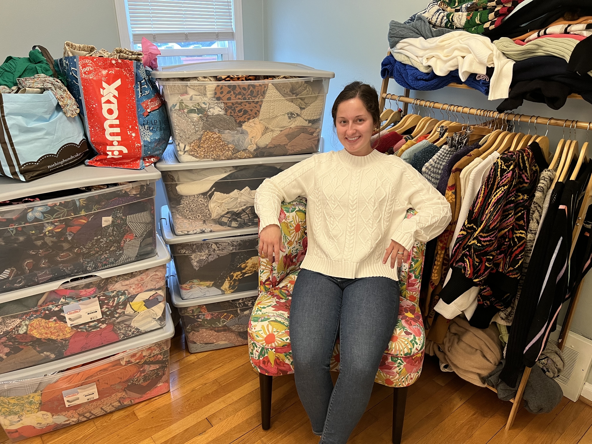 An image of a student in a closet of clothes