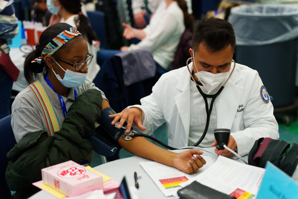 An image of a student checking another student