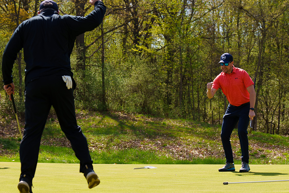 An image of people playing golf