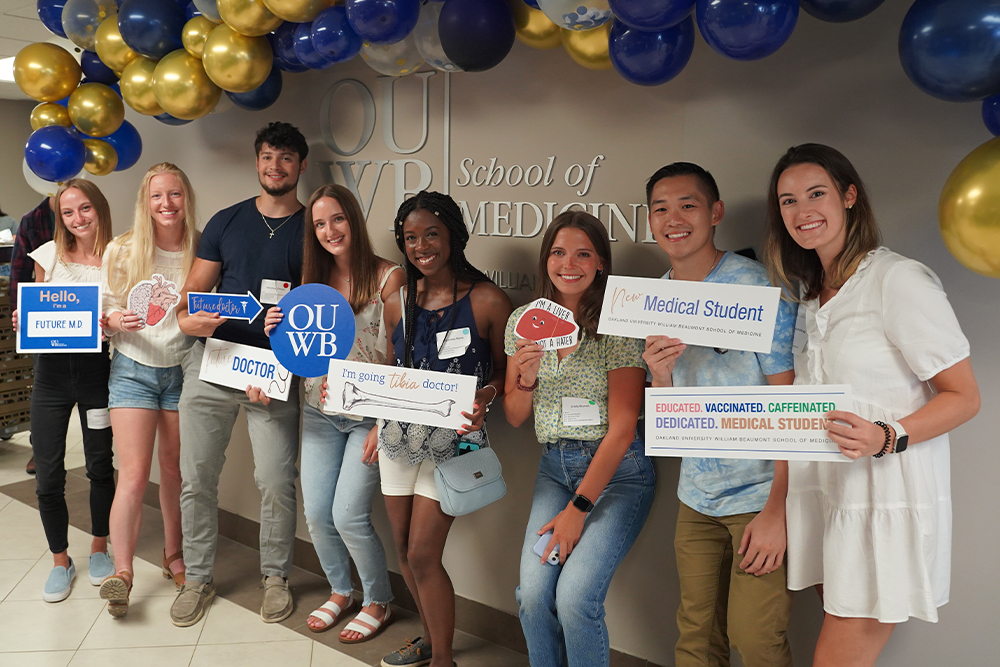An image of students holding signs during orientation
