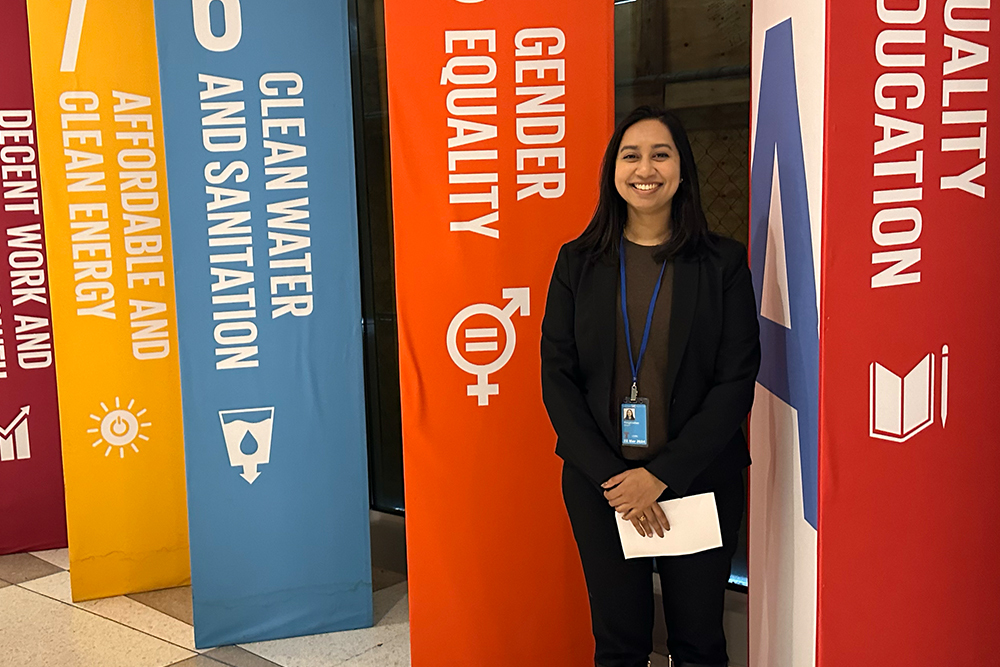 An image of a student in front of banners