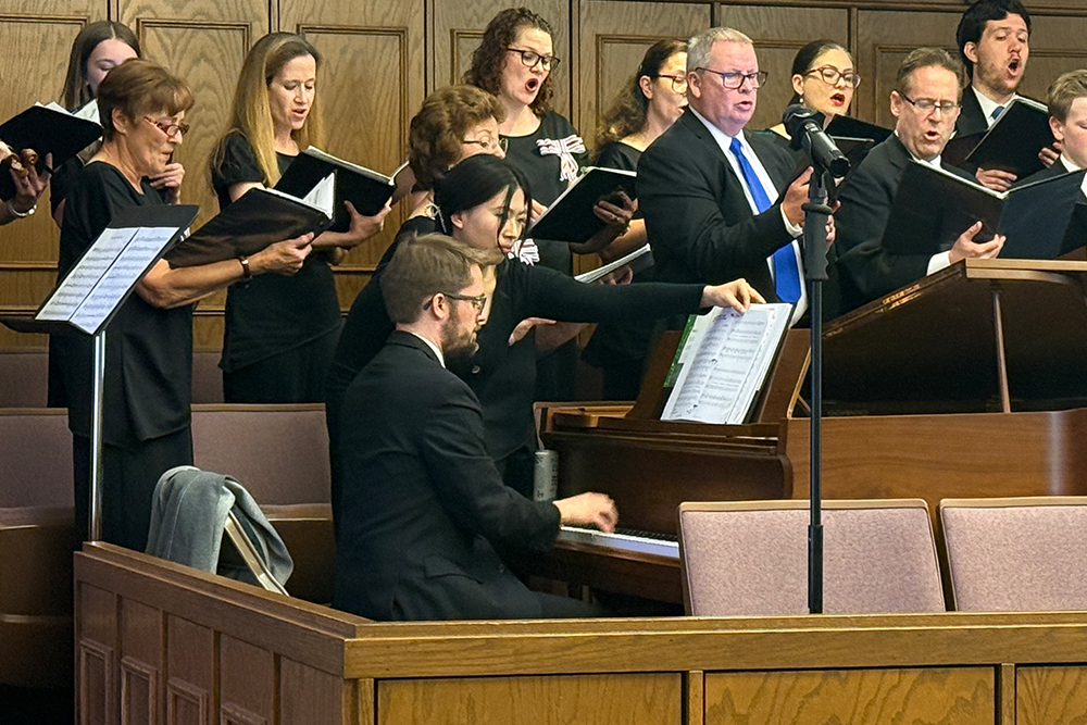 Drew Lewis plays piano with the choir