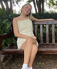 Anna Schmidt posing for a photo on a park bench