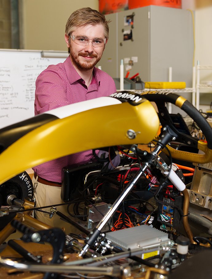 A person working on a race kart